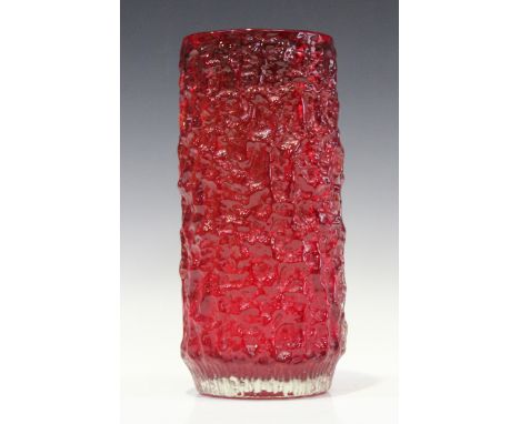 A Whitefriars ruby bark textured vase with fluted base, designed by Geoffrey Baxter, No. 9743, height 26.5cm.Buyer’s Premium 