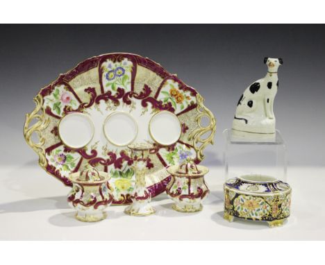 A Staffordshire porcelain inkstand of Rockingham type, mid-19th century, of oval shape with pierced scroll handles, painted w