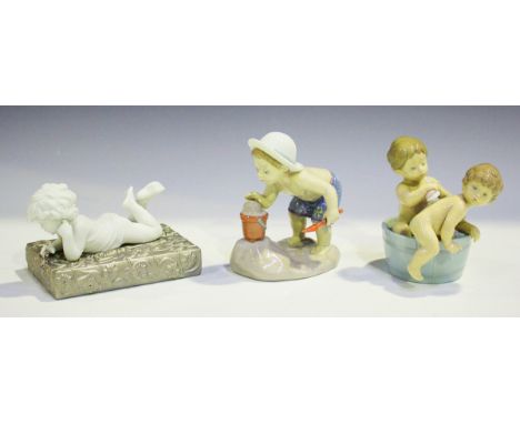 Three Lladro figures, comprising Wondering, No. 8280, boxed, Playing in the Sand, No. 8440, and Bath Time, No. 6411.Buyer’s P