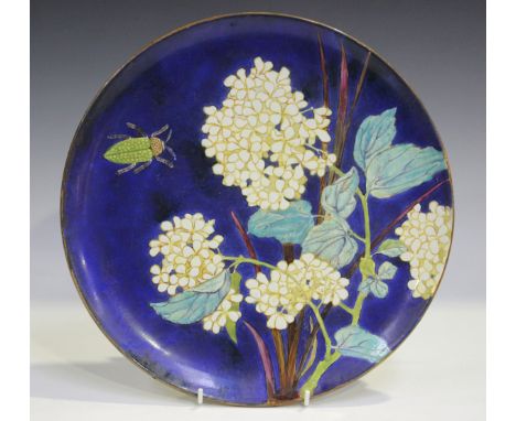 A Minton's Art Pottery Studio circular charger, circa 1870, painted with a green beetle by white hydrangea against a blue gro