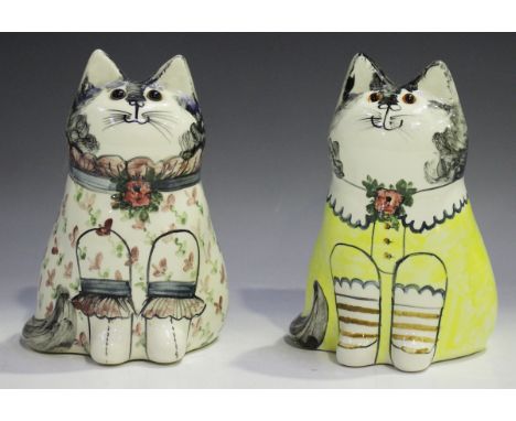 Two Joan and David De Bethel Rye Pottery cats, one dated 1988, each modelled seated wearing a colourful blouse, with glass se