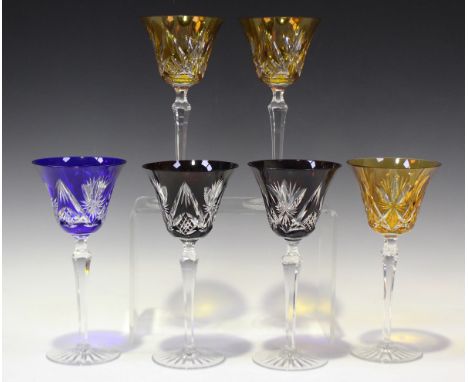 Six flashed and cut hock glasses, 20th century, with clear tapered hexagonal stems and star cut feet, comprising three amber,