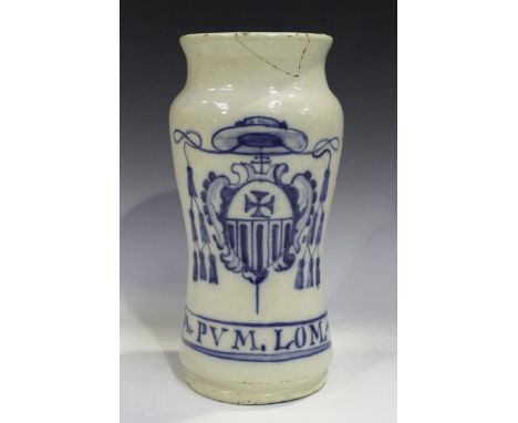 A Spanish faience monastic albarello, Talavera, late 17th/18th century, of waisted form, painted in blue with a Catholic armo