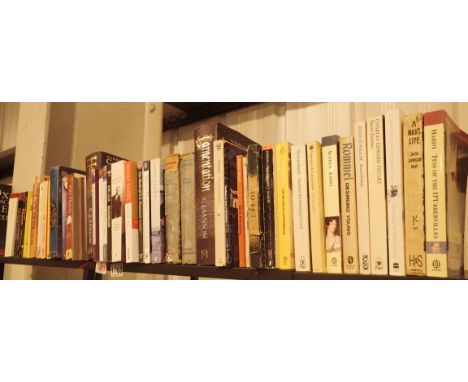 Shelf of mixed books, mainly paperback (top shelf)