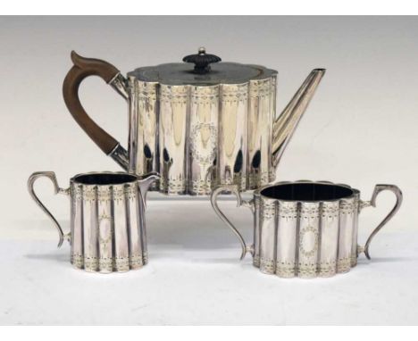 Victorian silver bachelor's three-piece tea set of oval ribbed form with bright-cut classical decoration, comprising teapot, 