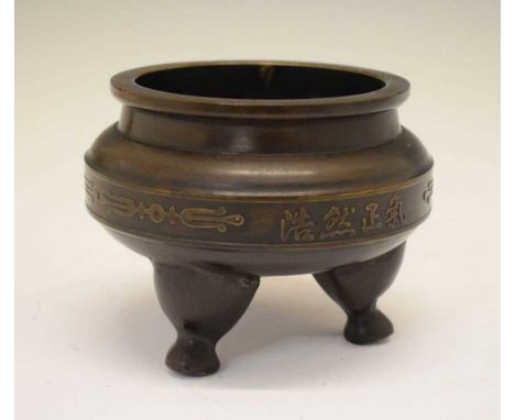 20th Century bronze tripod censer, of cauldron form with raised central band of repeating four-character script, on three squ