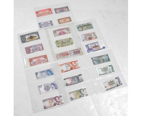 Good collection of approximately twenty UK and British Crown Dependencies banknotes to include a number of post-WWII British 