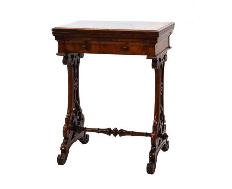 Mid-Victorian burr and figured walnut games table by Wilkinson &amp; Son, the rectangular foldout top revealing inlaid games 