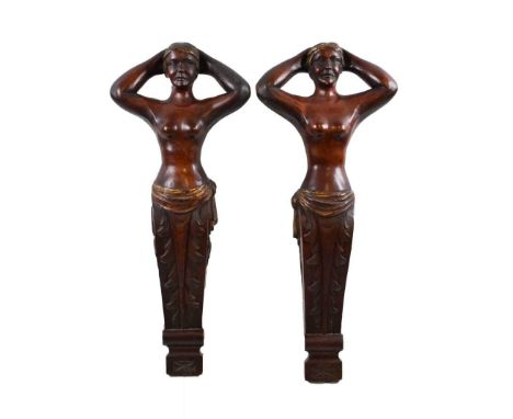 Pair of carved and gilded mahogany figural terms, circa 1900, each modelled as a semi-nude female with tapered acanthus embel
