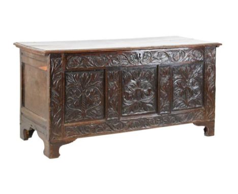 17th Century oak three-panel coffer or bedding chest, the hinged cover over frieze, three panels and end stiles all profusely