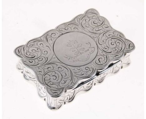 Edward VII silver snuff box of shaped rectangular form with engraved floral scroll decoration, the hinged lid opening to reve