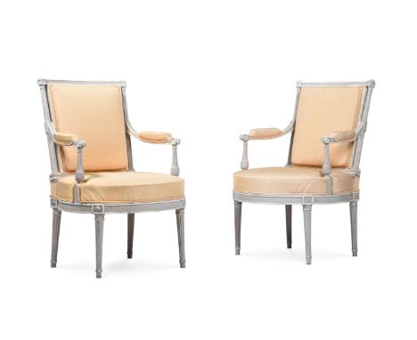 A PAIR OF TRANSITIONAL PERIOD OPEN ARMCHAIRS FRENCH CIRCA 1770 Later white painted, gold fabric upholstered with repeating fl