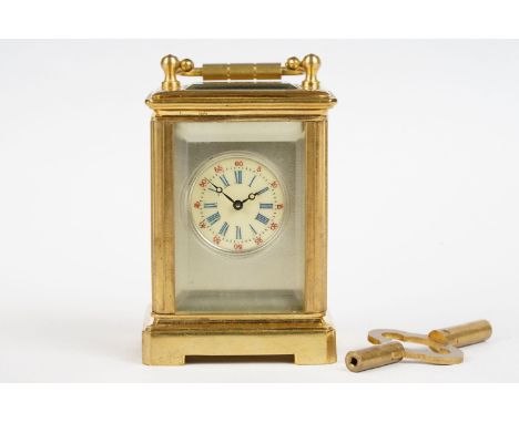 A miniature antique brass cased carriage clock with enamel panels with cherub decoration. 