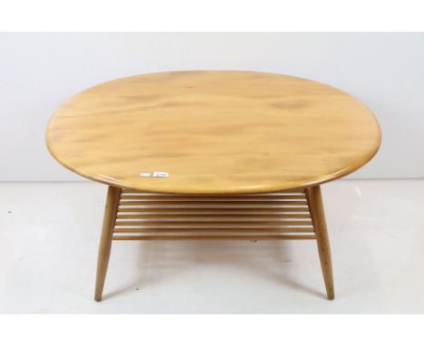 Ercol Pale Elm and Beech Oval Coffee Table, model 454 with spindle undershelf, 44cm high x 100cm wide x 82cm deep 