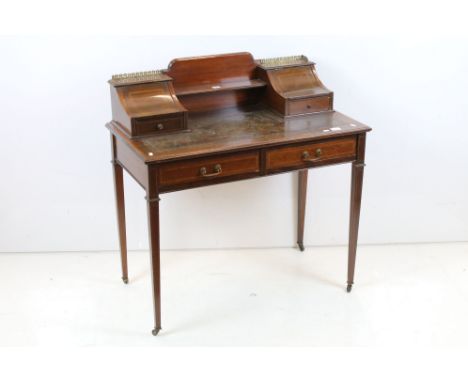 Edwardian Mahogany Carlton House style Writing Desk, the superstructure with pierced brass gallery rails, open shelf flanked 