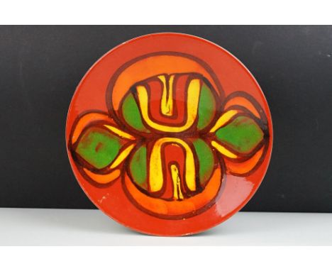 Poole Pottery Delphis red ground shallow dish, appox 26.5cm diameter, monogram to reverse, shape no. 4 
