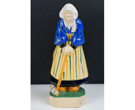 Henriot Quimper figure of an elderly lady, circa 1930's, with polychrome decoration, designed by L. H. Nicot, numbered 134 to