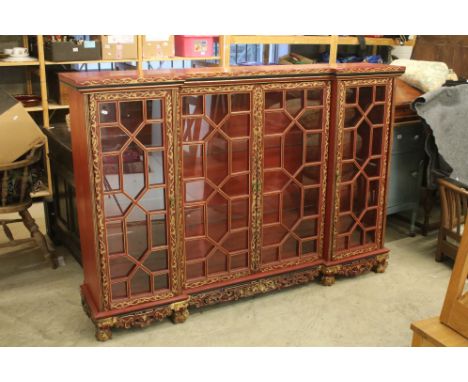 Red Lacquered and Gilt decorated Inverted Breakfront Display Cabinet in the Chinese manner, the central twin glazed doors ope