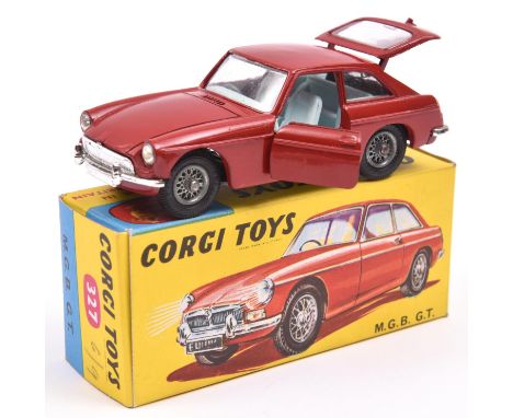 Corgi MGB GT (327). In deep red with mid blue interior, spoked wheels and black tyres, with black suitcase.Boxed with Corgi C