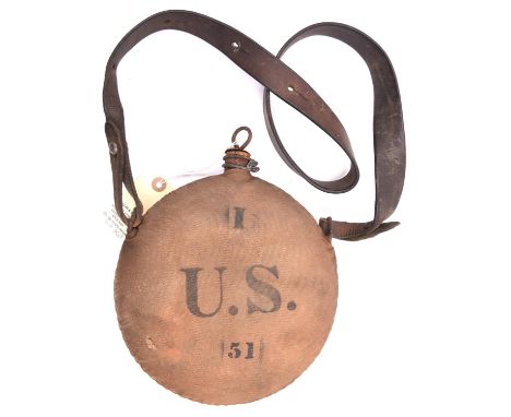A 19th century US brown canvas covered water bottle,  stamped I/U.S./51 of circular form with leather shoulder strap, cork st