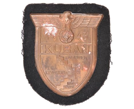 A Third Reich Kuban shield,  with black cloth patch and original paper backing. GC (small patch of verdigris) 