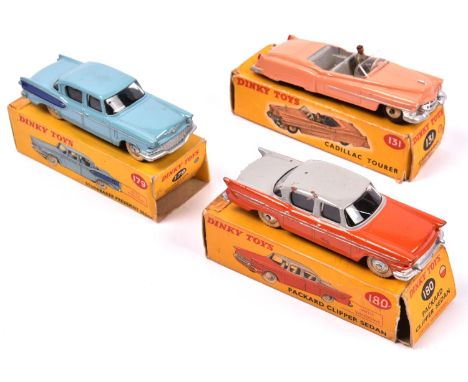 3 Dinky Toys. Cadillac Tourer (131) in pink with light grey interior and cream wheels, complete with driver. Plus a Studebake