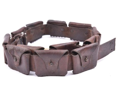 A brown leather bandolier of 12 pouches,  each to hold 5 .303 cartridges, marked “Martin’s Patent. Birmingham” (faint) in pan