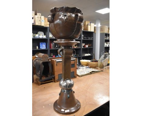 An arts and crafts style Bretby jardiniere and stand 87cm tall approx having copper effect finish
Base in good condition over