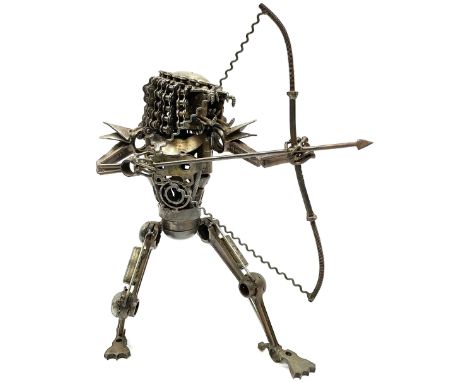 Predator metal sculpture, made with scrap metal, with articulated body, bike chain hair, and bow and arrow, H45cm