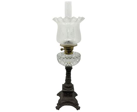 Victorian cast spelter oil lamp, the quatrefoil base on four paw feet leading to a square plinth and column decorated with pu