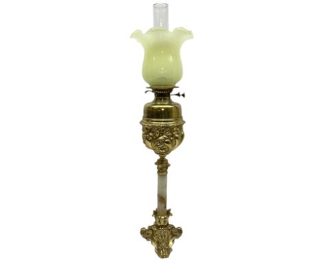 Gilt brass oil lamp, the cast base modelled with putti and mask amidst foliate scrolls, upon two scroll and one paw feet, lea