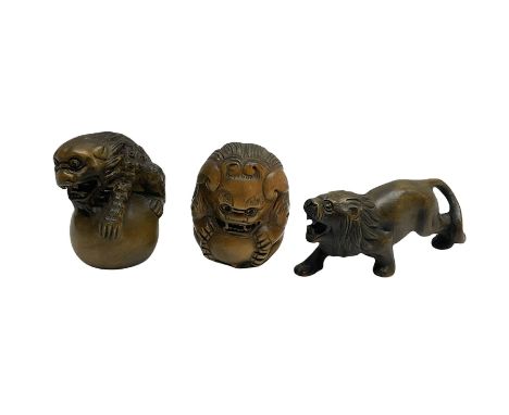 Three netsuke, modelled as two mythical creatures and a lion