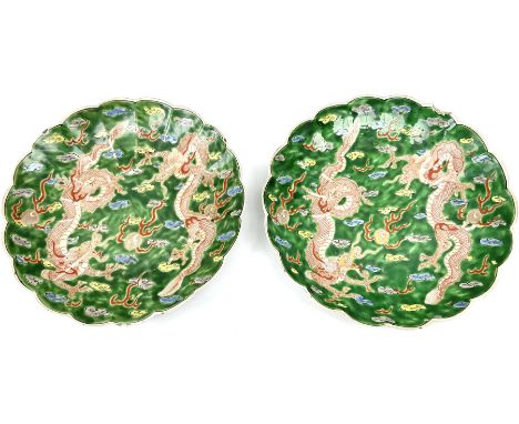 Pair of Japanese Meiji period plates, of circular form with lobed rims, each decorated with two red three clawed dragons chas