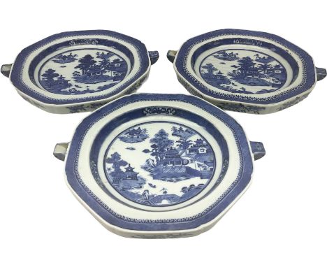 Three late 18th/early 19th century Chinese export hot water plates, of octagonal form decorated with landscape set with pagod