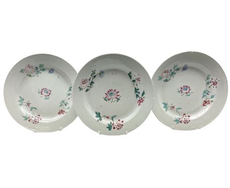 Three 18th century Chinese porcelain plates, each decorated with flowers upon a white ground, D22.5cm