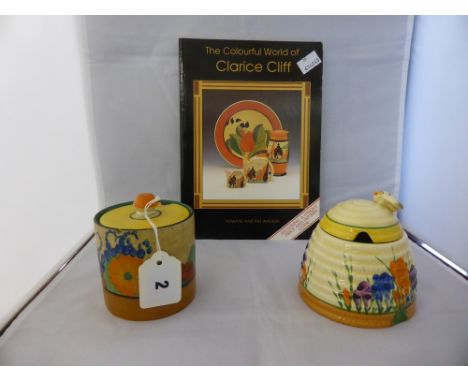 Clarice Cliff crocus pattern beehive honey pot, 4in. (10.1cm.) high, together with a Clarice Cliff floral patterned preserve 