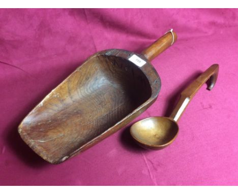 A large antique wooden grain scoop and a wooden ladle