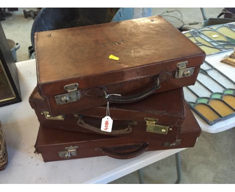 Three small vintage leather suitcases