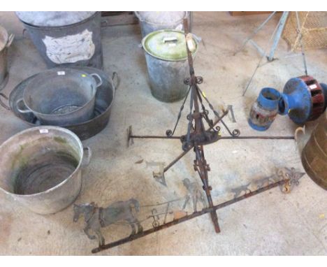 A vintage weather vane depicting working horse and dogs