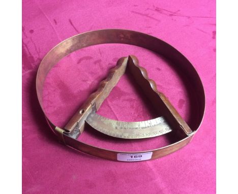 A vintage brass hat measuring tool