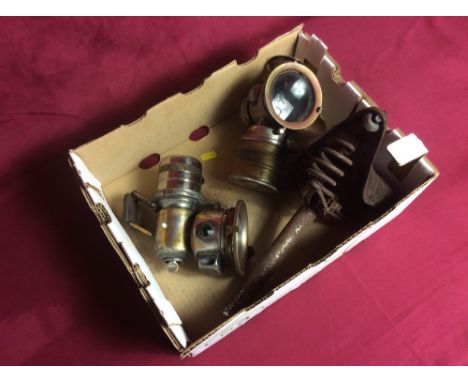 Two vintage carbide lamps and a leather cycle saddle