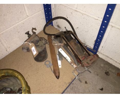 A vintage blow torch, a loom shuttle, an old foot pump, traps etc.