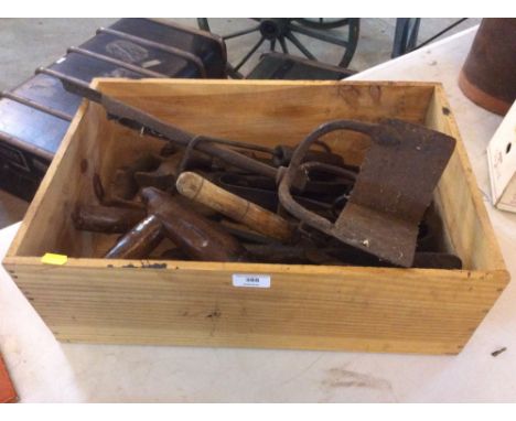 A tray of various agricultural hand tools