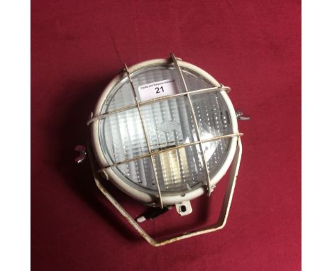 A small white metal spot light, originally from a tractor