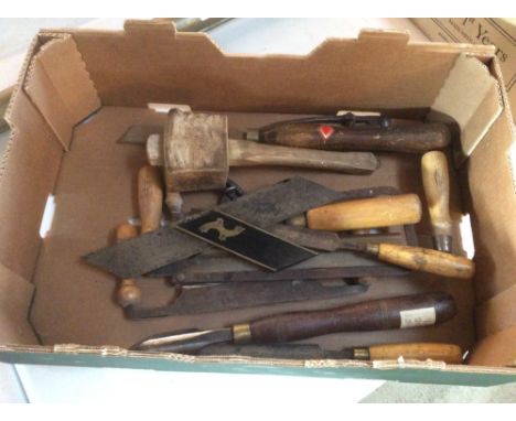 A box of vintage woodworking tools including chisels, saws etc.