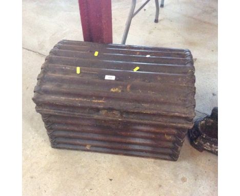 An old domed tin trunk of ribbed design
