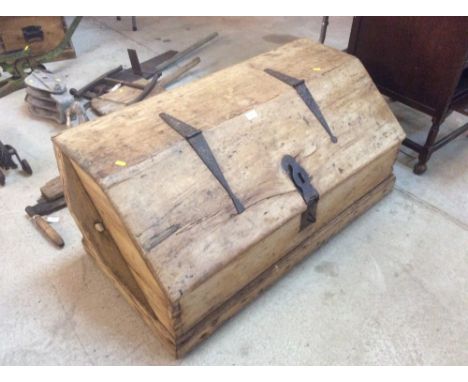 A 19th Century stripped pine sloping top trunk with iron hinges and hasp