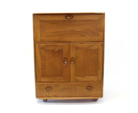 Ercol "Windsor" Golden Elm Bureau / Drinks Cabinet Model 469, the fall-front enclosing fitted interior above twin cupboard do