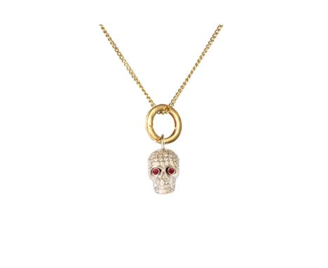 A jewelled ruby and diamond skull pendant and chain designed as a white gold skull jewelled with round cut diamonds and ruby 