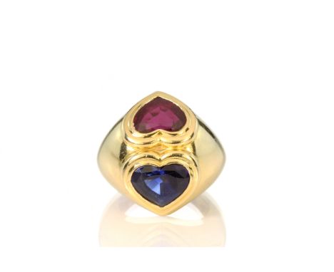 A Bulgari style ruby and sapphire double heart ring in 18ct yellow gold the graduated gold band set with two juxtaposed heart